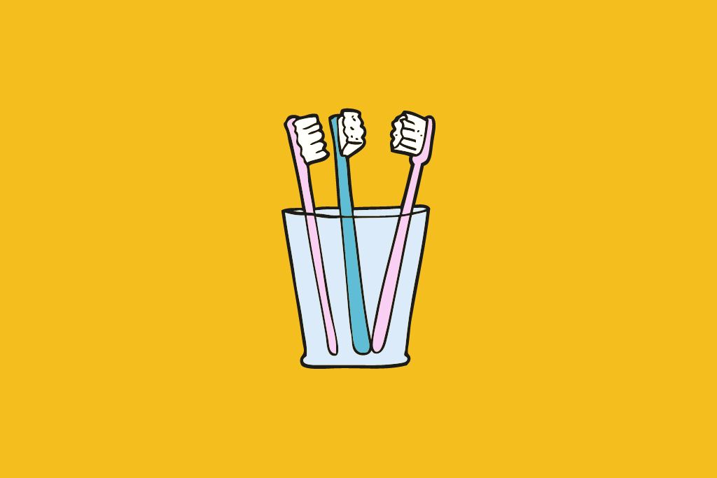 three toothbrushes in a glass